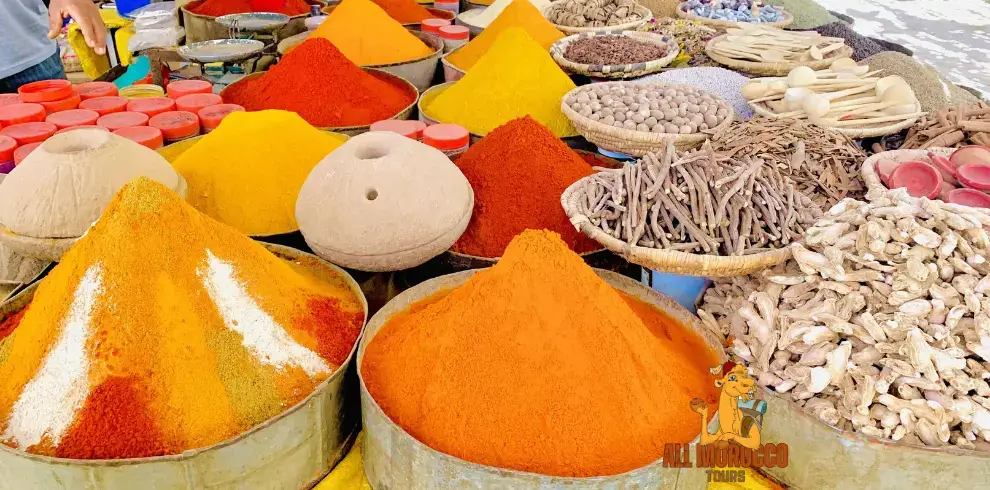 Colorful spice piles on display in a market in Rissani during a 4-day trip from Errachidia to Marrakech