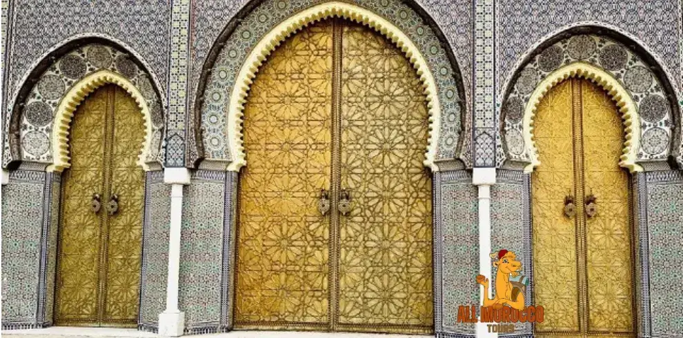 Ornate golden doors flanked by intricate mosaic arches at the Royal Palace of Fez, showcasing the traditional Moroccan architecture one can expect to see on a 10-day desert tour starting from Casablanca.