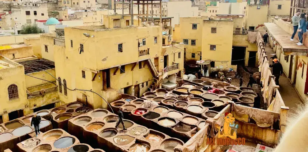 The ancient Chouara Tannery in Fes comes to life with workers busily processing leather in numerous stone vats filled with dyes a historic site often visited during 3-day desert trips from Fes.