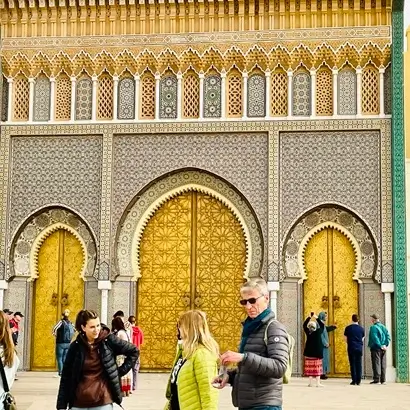 visiting the large decorative golden doors of the King's Palace in Fes a popular stop on Fes city tours