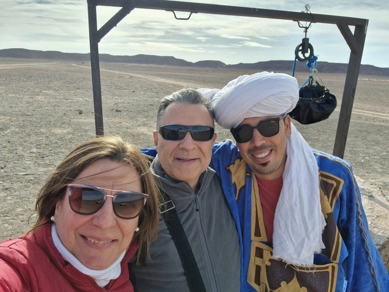 Travelers in the desert mountains near Erfoud on a 3 day desert tour from Fes to Merzouga