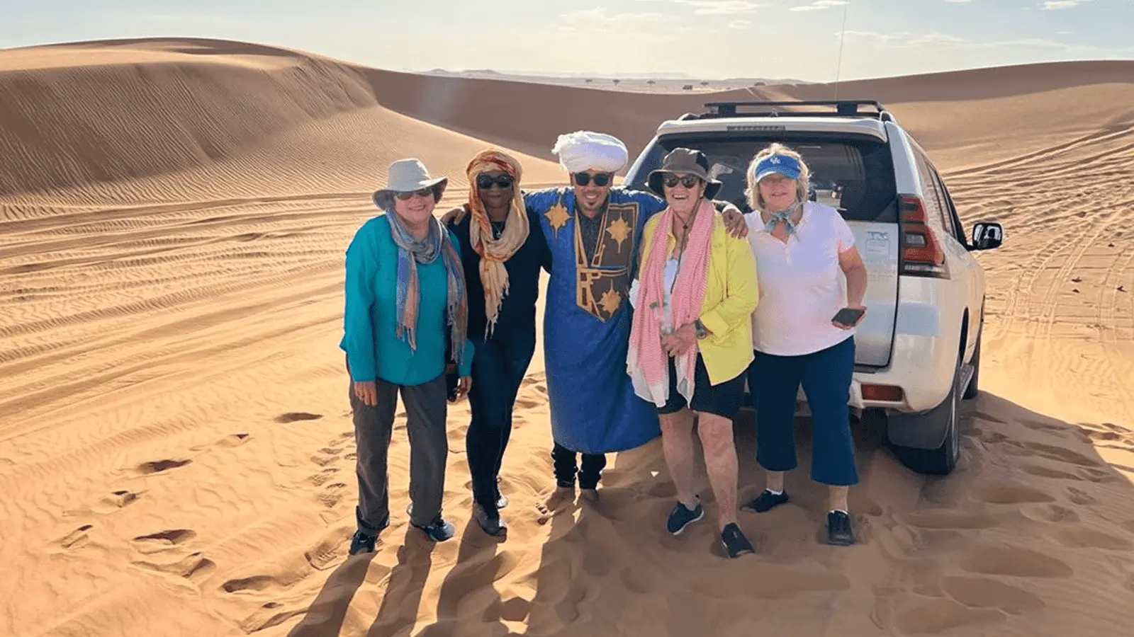 Travelers enjoying a 4x4 desert excursion in the Erg Chebbi sand dunes during a 6 Days Tour from Tangier to Marrakech