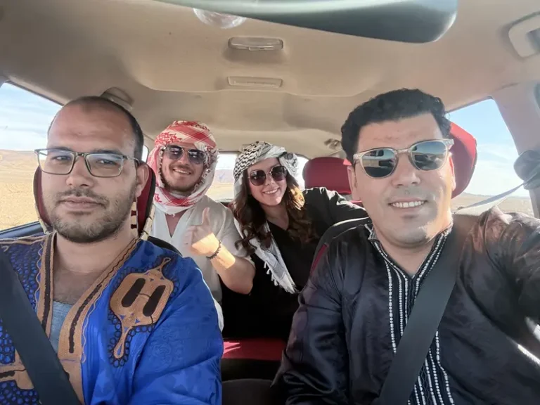 Travelers beginning a desert adventure in a 4x4 during a tour from Fes