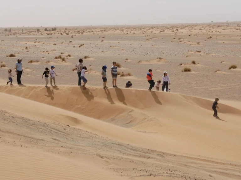 Children and families exploring the Erg Chebbi dunes during a Morocco desert tour