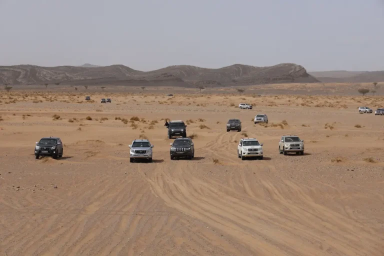 4x4 vehicles crossing the Sahara Desert on a 4-day Fes to Marrakech desert tour in Morocco