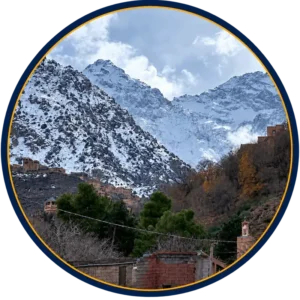 Snow-covered Atlas Mountains above a traditional village in Morocco