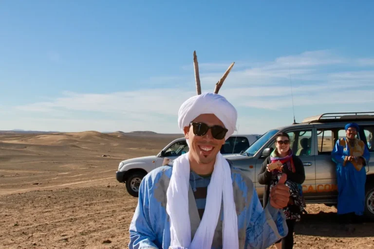 Local guide beside 4×4 vehicles during a 3-day Fes to Merzouga desert tour
