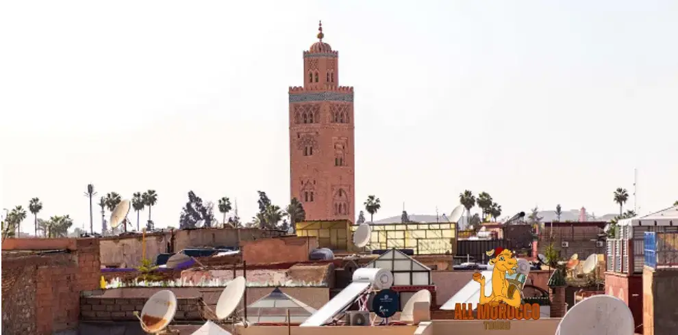 Koutoubia Mosque minaret rising above rooftops in Marrakech, Morocco